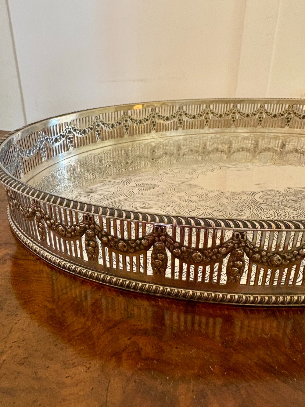An oval antique Edwardian silver-plated gallery tray featuring intricate floral surface chasing and a raised pierced rim. View VI
