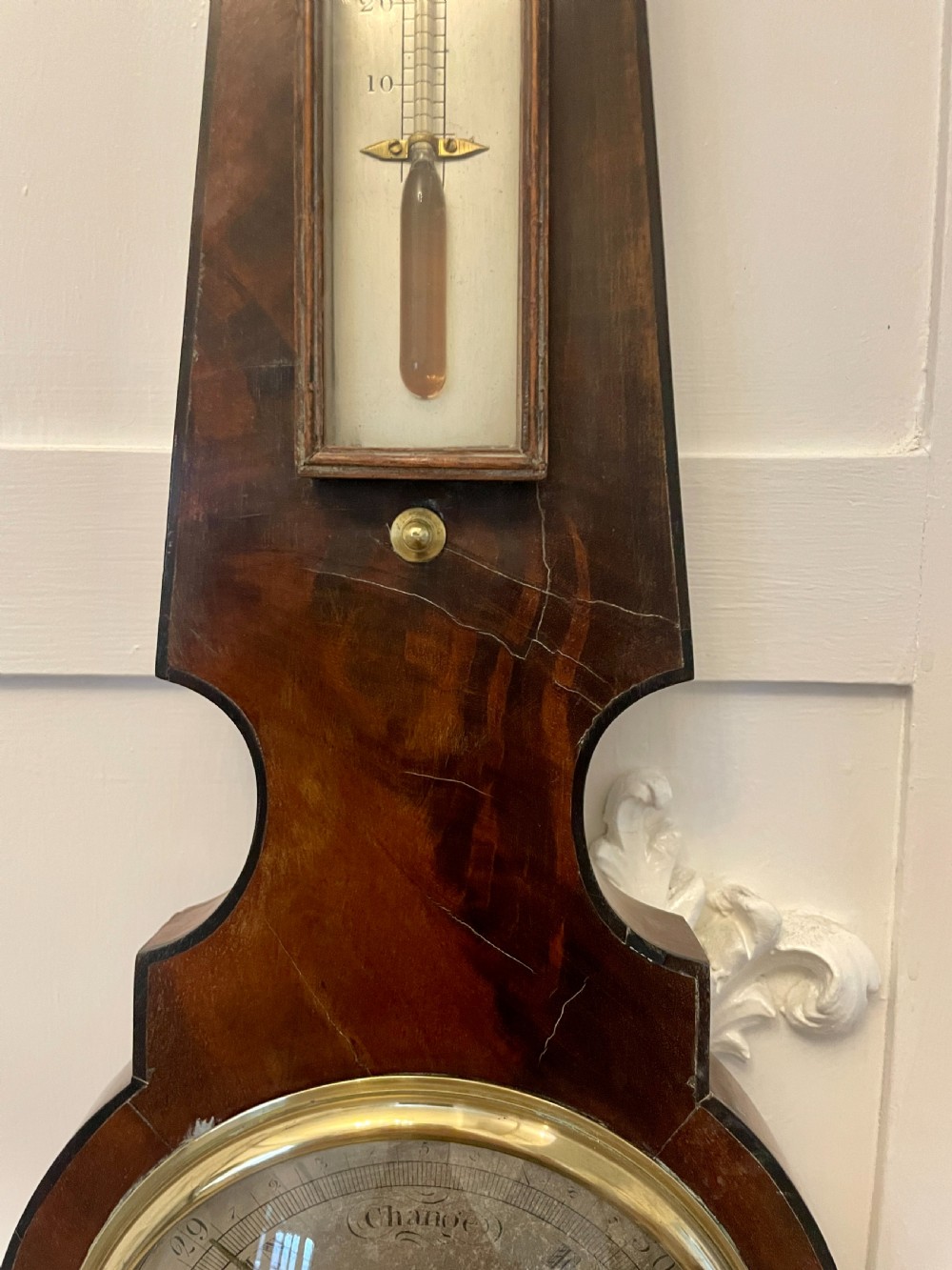 A vertical George III mahogany banjo barometer featuring a pediment top, glass thermometer tube, silvered dial, and brass bezel. View IX