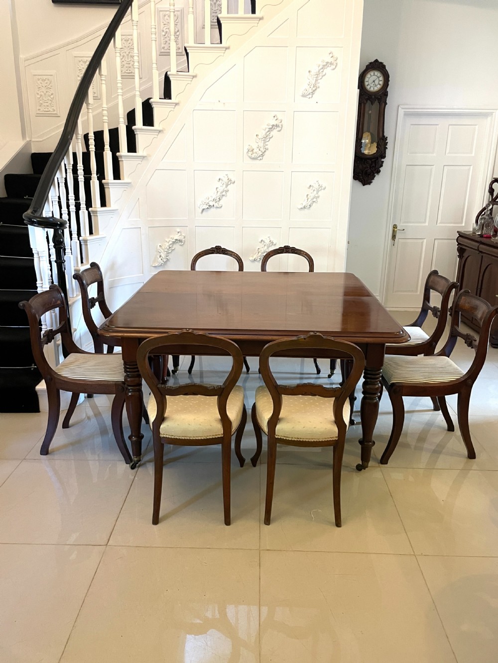 A large Victorian extending mahogany dining table featuring turned legs fitted with brass castors and a polished top with rounded corners. View VIII