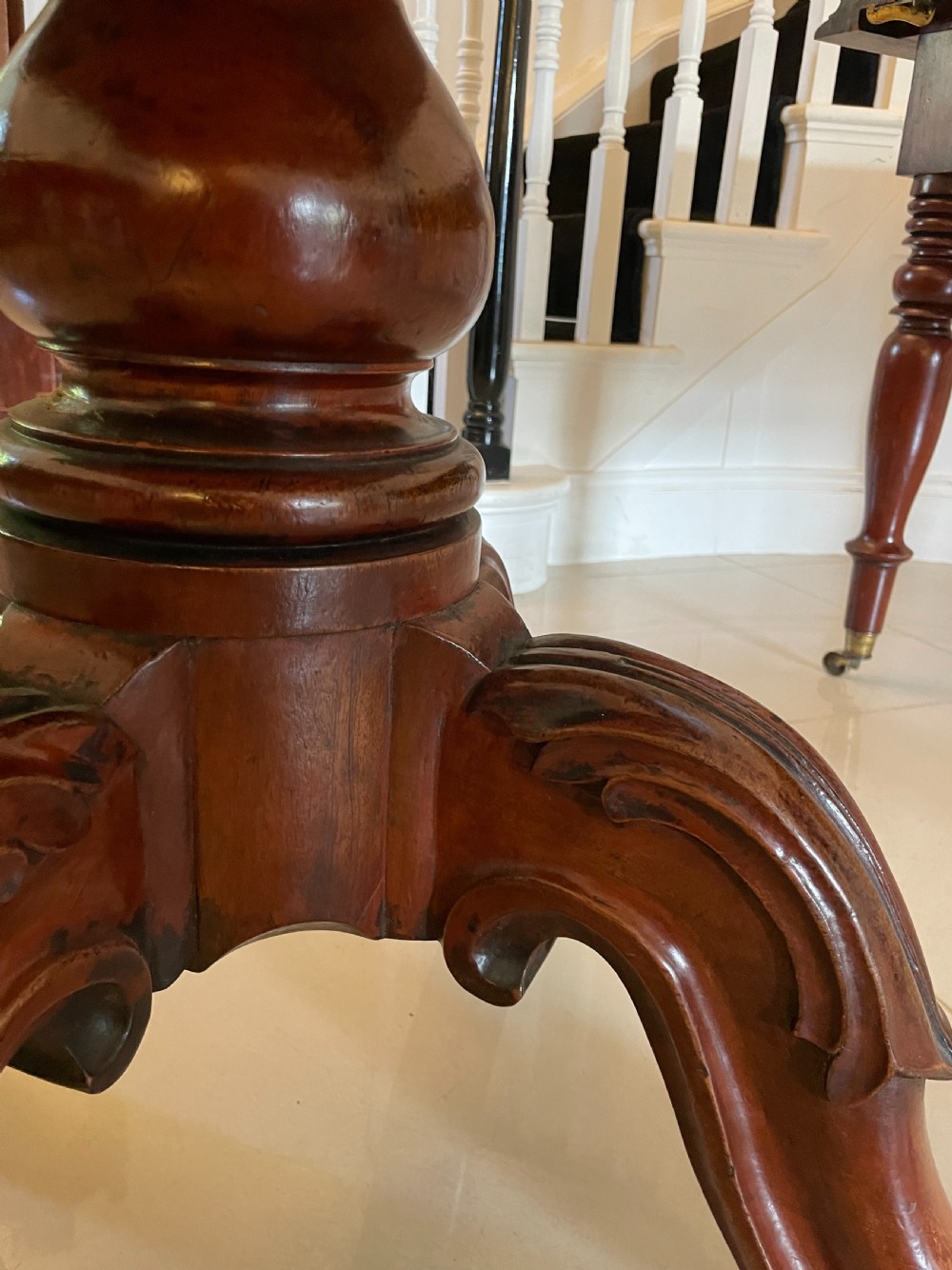 A large Victorian extending mahogany dining table featuring turned legs fitted with brass castors and a polished top with rounded corners. View IX