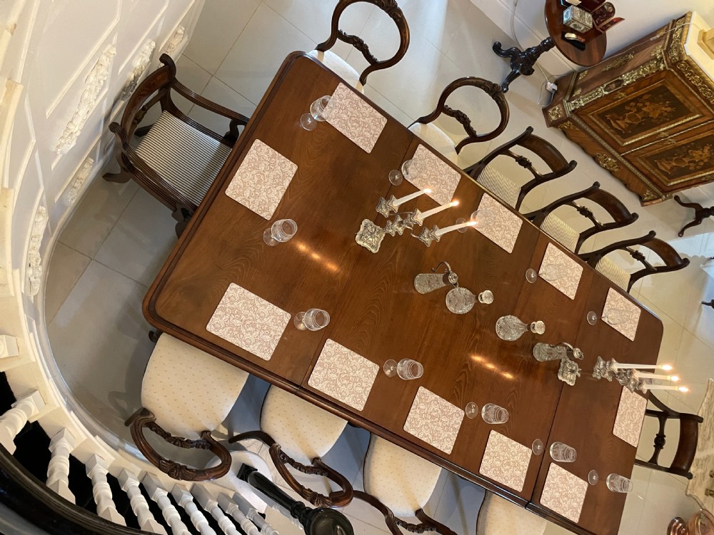 A large Victorian extending mahogany dining table featuring turned legs fitted with brass castors and a polished top with rounded corners. View XV