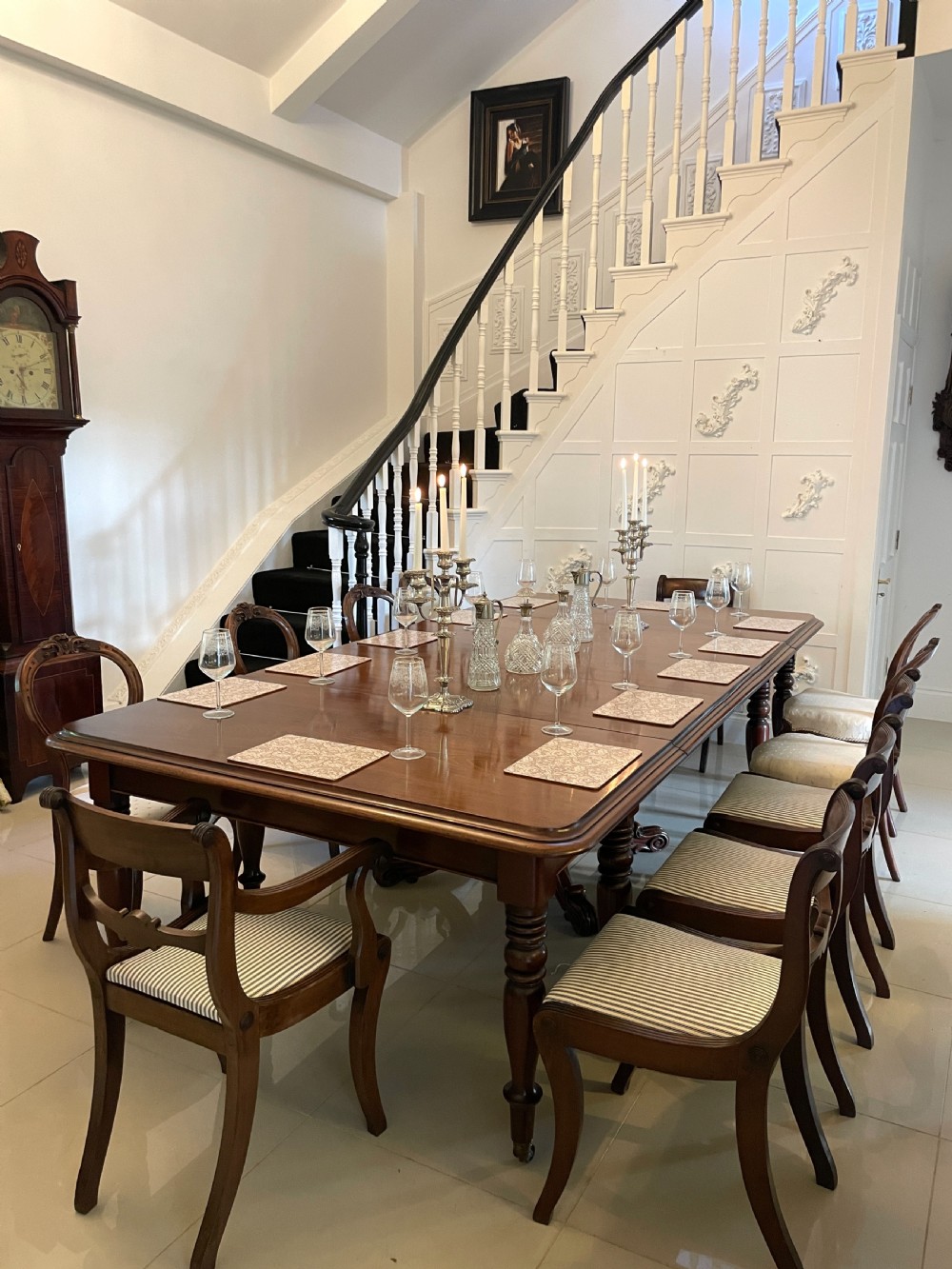 A large Victorian extending mahogany dining table featuring turned legs fitted with brass castors and a polished top with rounded corners. View XVIII