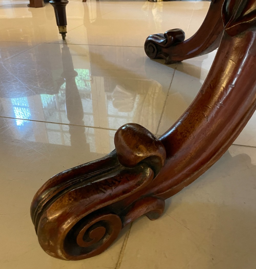 A large Victorian extending mahogany dining table featuring turned legs fitted with brass castors and a polished top with rounded corners. View XXII