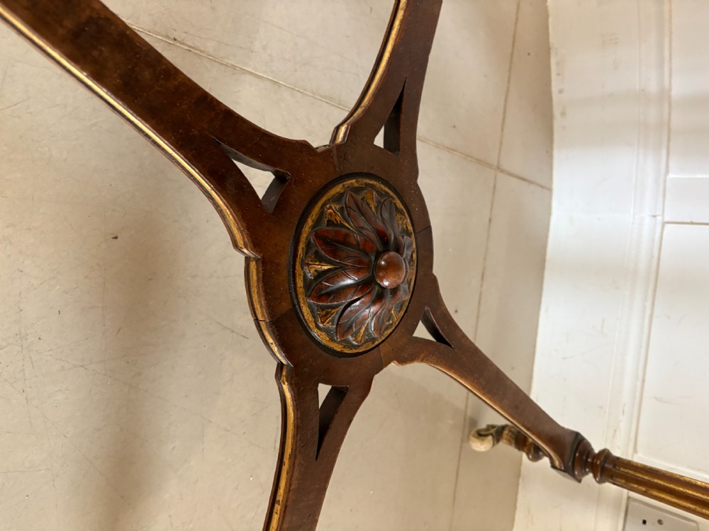 A Victorian burr walnut centre table with a lobed shaped top, inlaid crossbanding, turned legs, and an X-form stretcher on castors. View VII