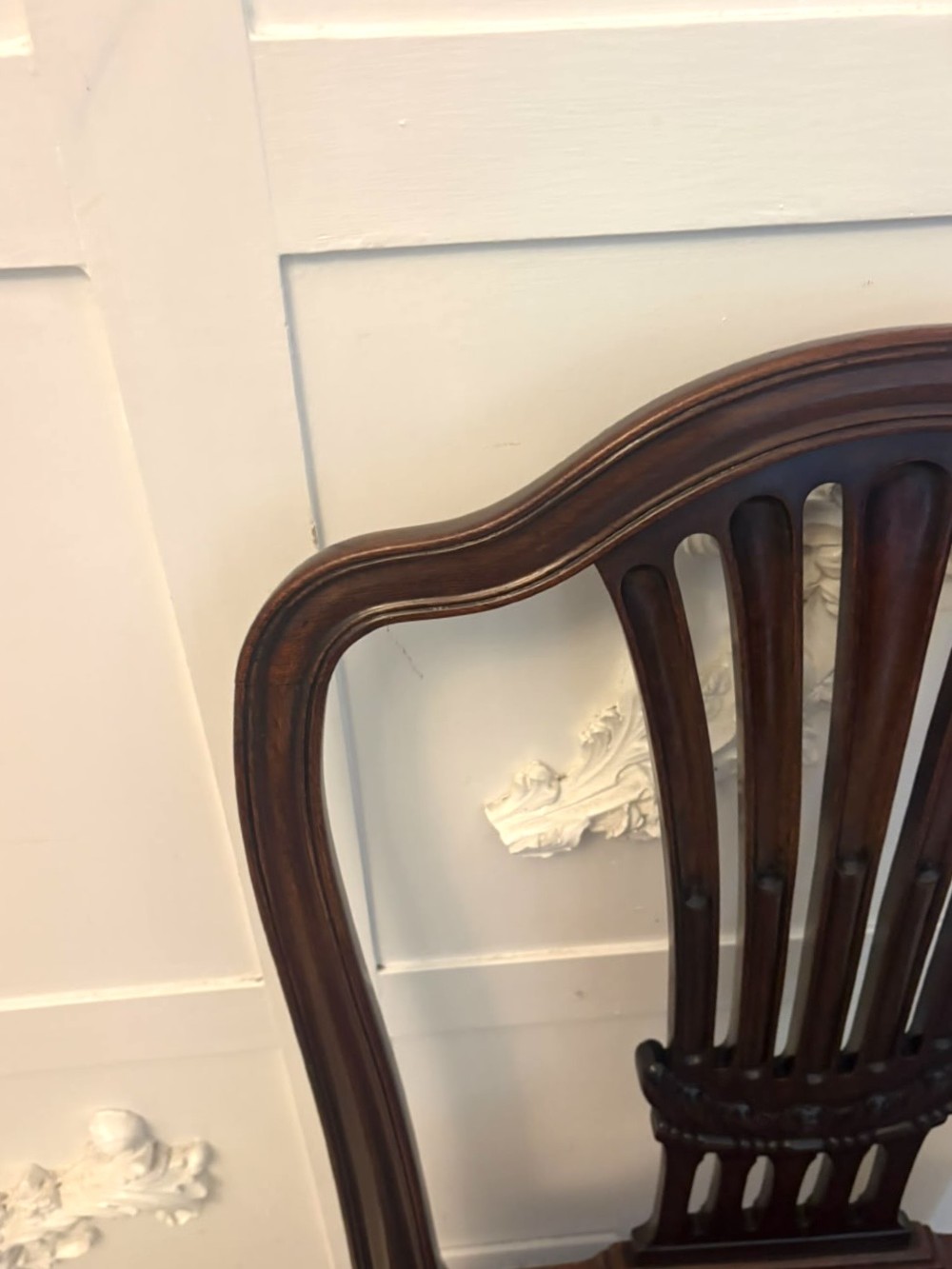 A set of Victorian mahogany Hepplewhite style dining chairs featuring shield-shaped backs with carved splats and tan leather upholstered seats. View VIII