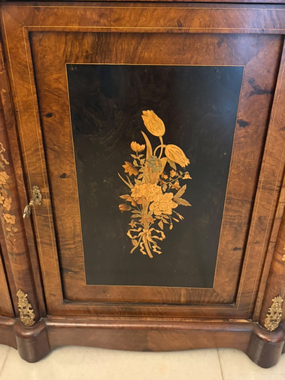 A nineteenth-century Victorian burr walnut credenza featuring curved side doors, intricate floral marquetry inlays, and gilt bronze mounts. View IX