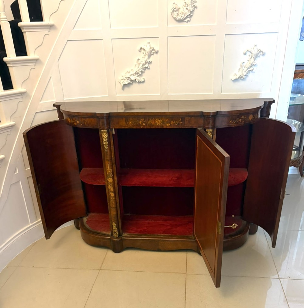A nineteenth-century Victorian burr walnut credenza featuring curved side doors, intricate floral marquetry inlays, and gilt bronze mounts. View XV