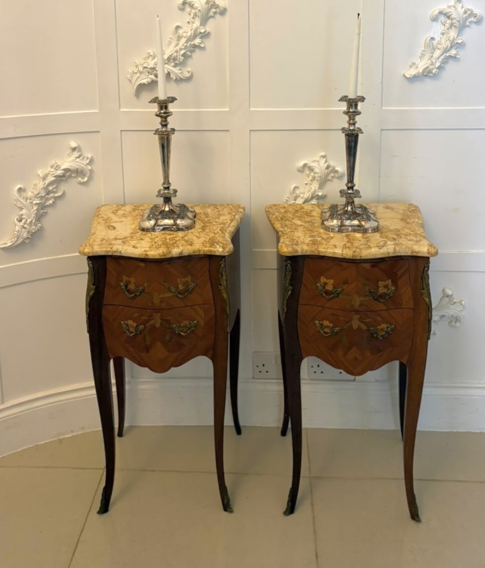 A pair of French Louis XV style kingwood bedside cabinets featuring floral marquetry inlays, gilt bronze mounts, serpentine fronts, and shaped marble tops. View VII