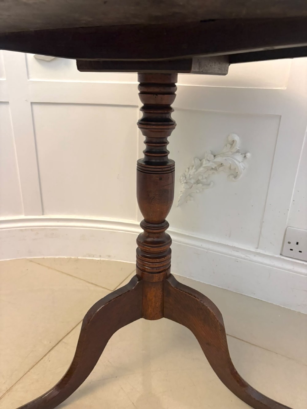 An 18th-century Georgian burr oak tilt-top occasional table featuring a circular surface, turned pedestal column, and tripod base shown upright. View II