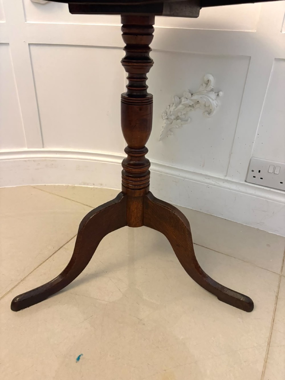 An 18th-century Georgian burr oak tilt-top occasional table featuring a circular surface, turned pedestal column, and tripod base shown upright. View III