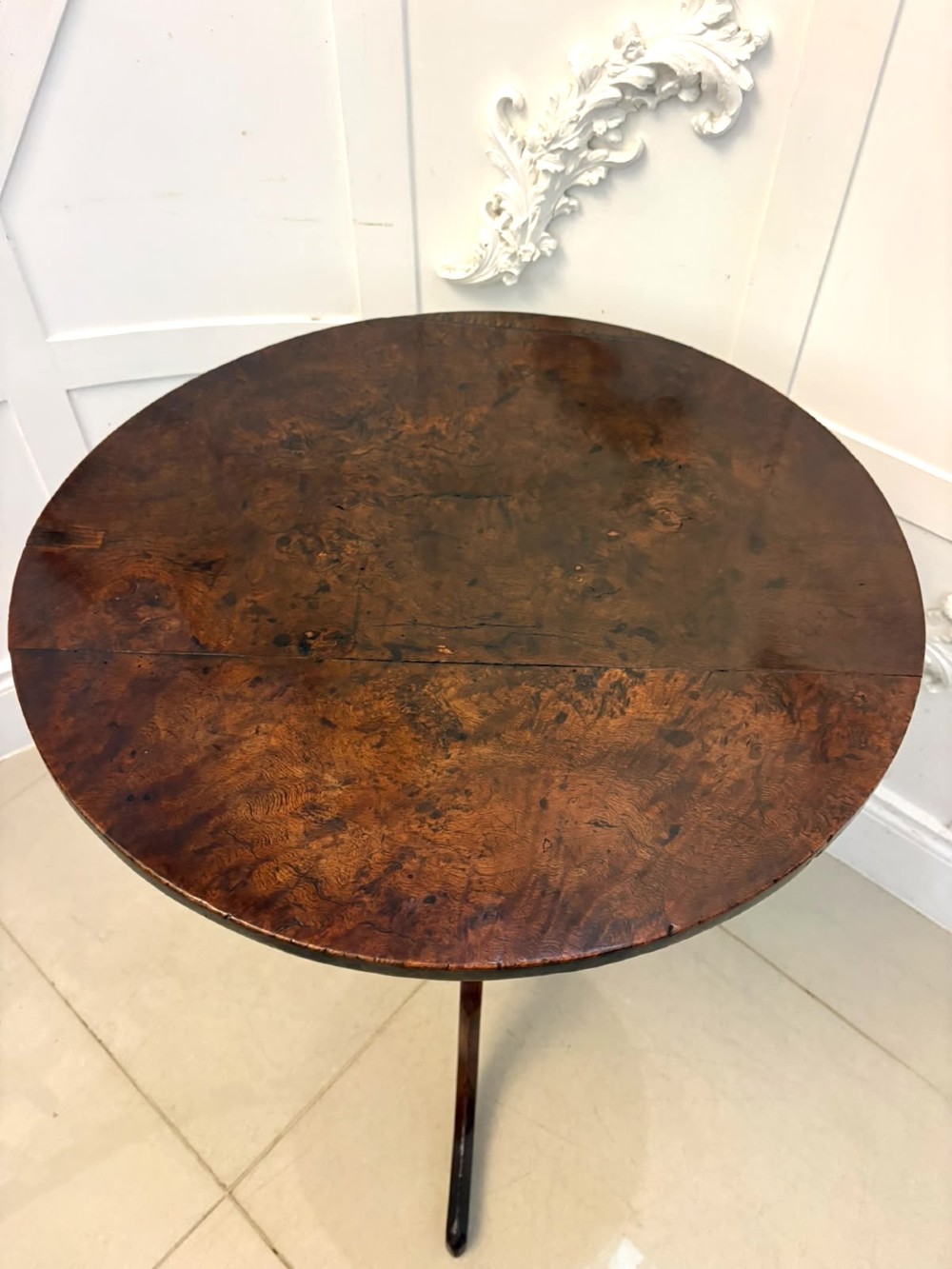 An 18th-century Georgian burr oak tilt-top occasional table featuring a circular surface, turned pedestal column, and tripod base shown upright. View IV