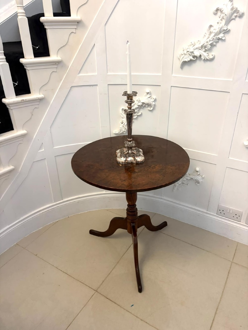An 18th-century Georgian burr oak tilt-top occasional table featuring a circular surface, turned pedestal column, and tripod base shown upright. View V