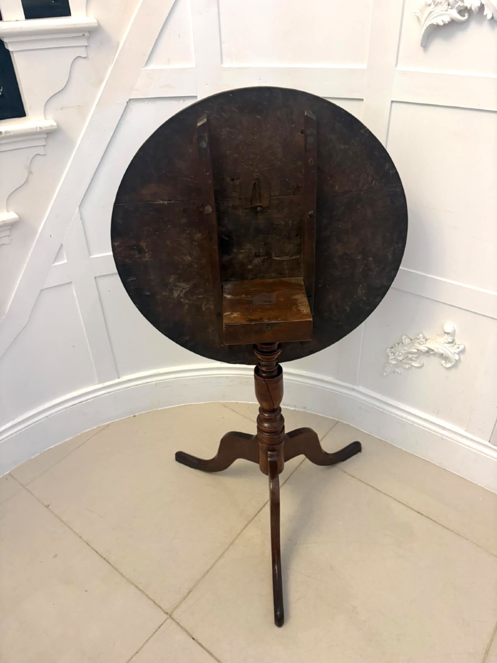 An 18th-century Georgian burr oak tilt-top occasional table featuring a circular surface, turned pedestal column, and tripod base shown upright. View VI