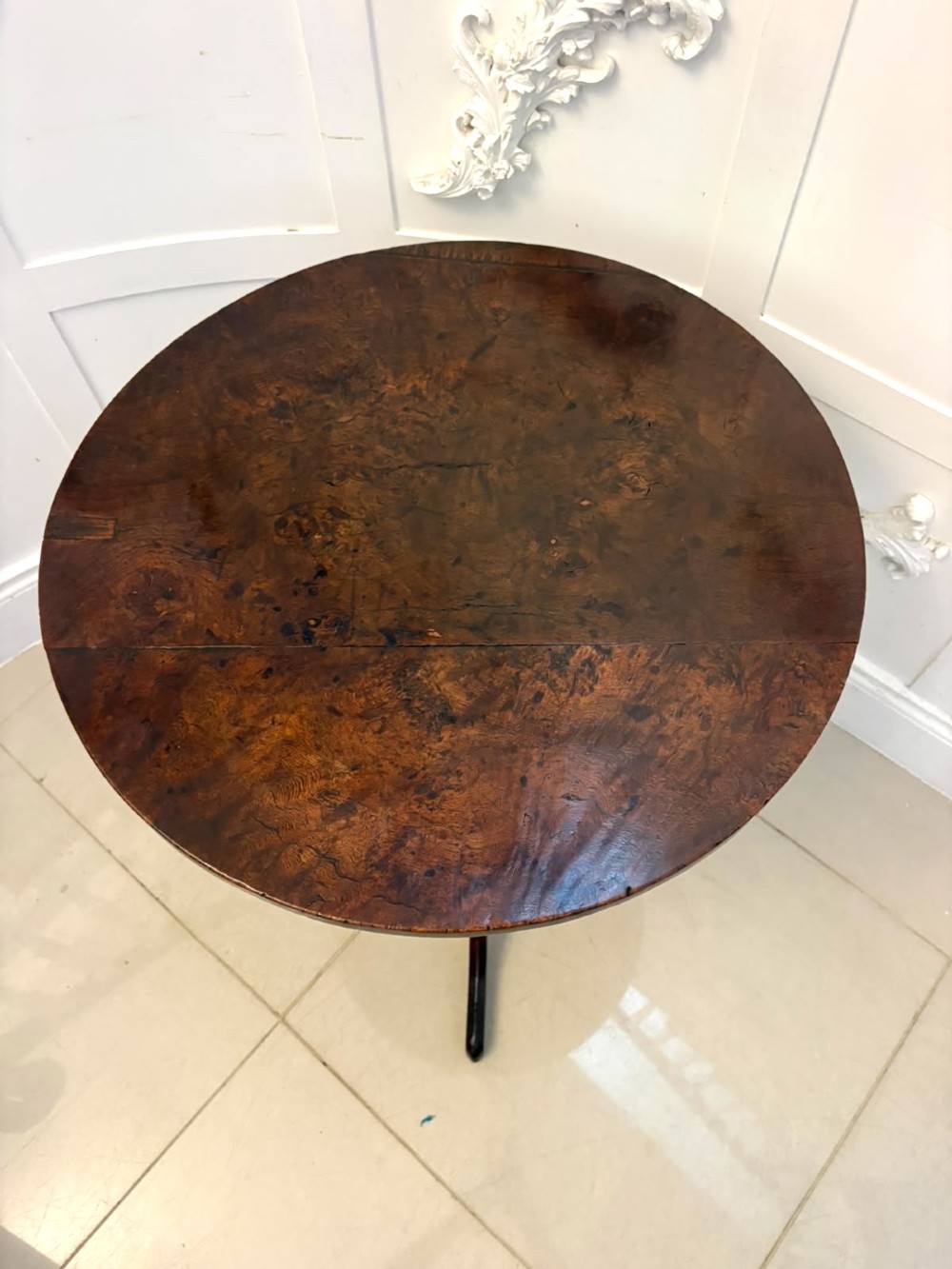 An 18th-century Georgian burr oak tilt-top occasional table featuring a circular surface, turned pedestal column, and tripod base shown upright. View VII