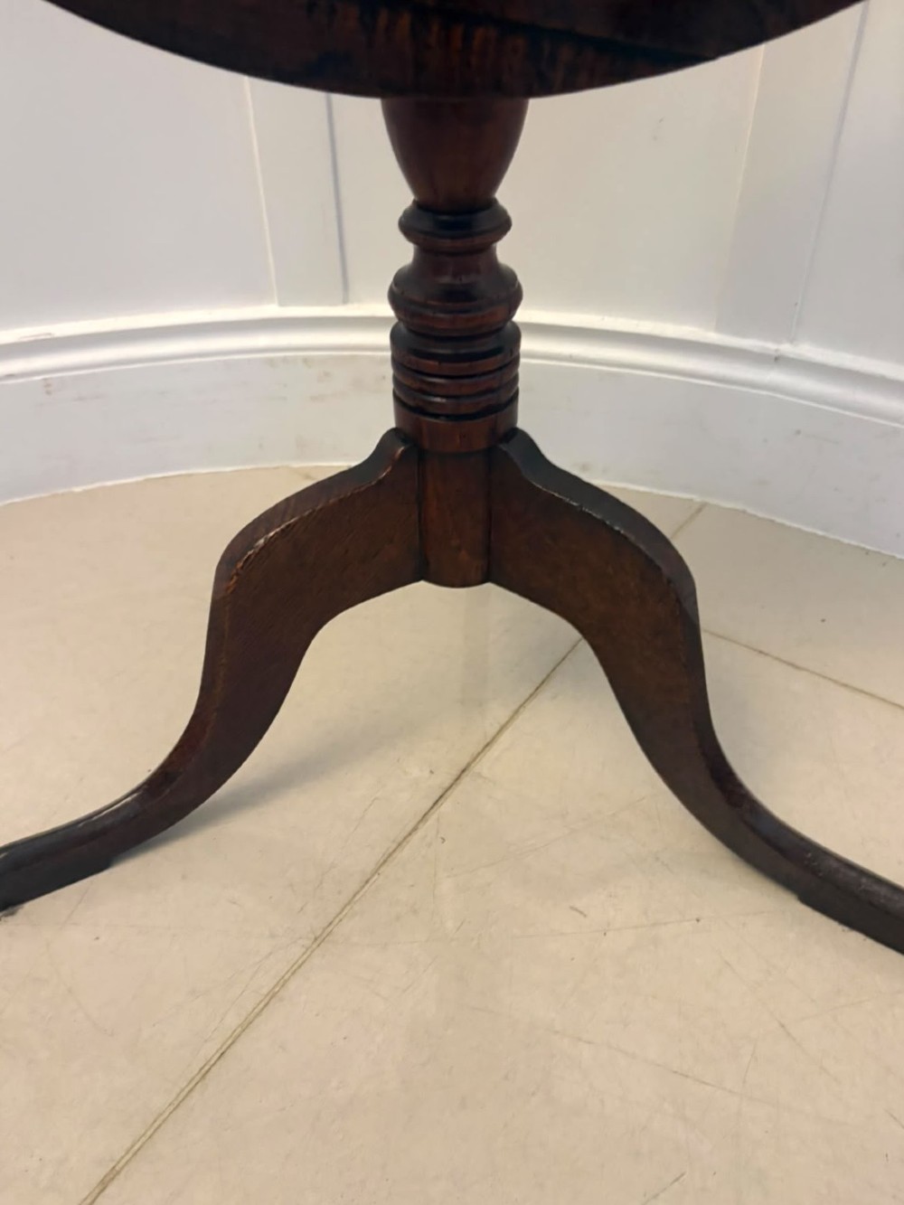 An 18th-century Georgian burr oak tilt-top occasional table featuring a circular surface, turned pedestal column, and tripod base shown upright. View VIII