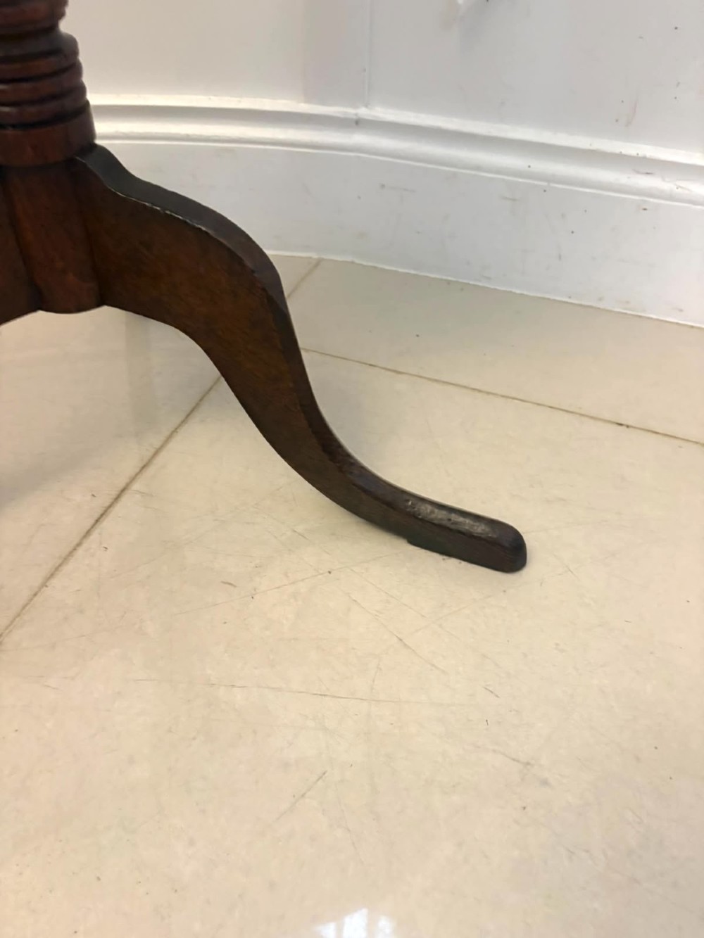 An 18th-century Georgian burr oak tilt-top occasional table featuring a circular surface, turned pedestal column, and tripod base shown upright. View XI