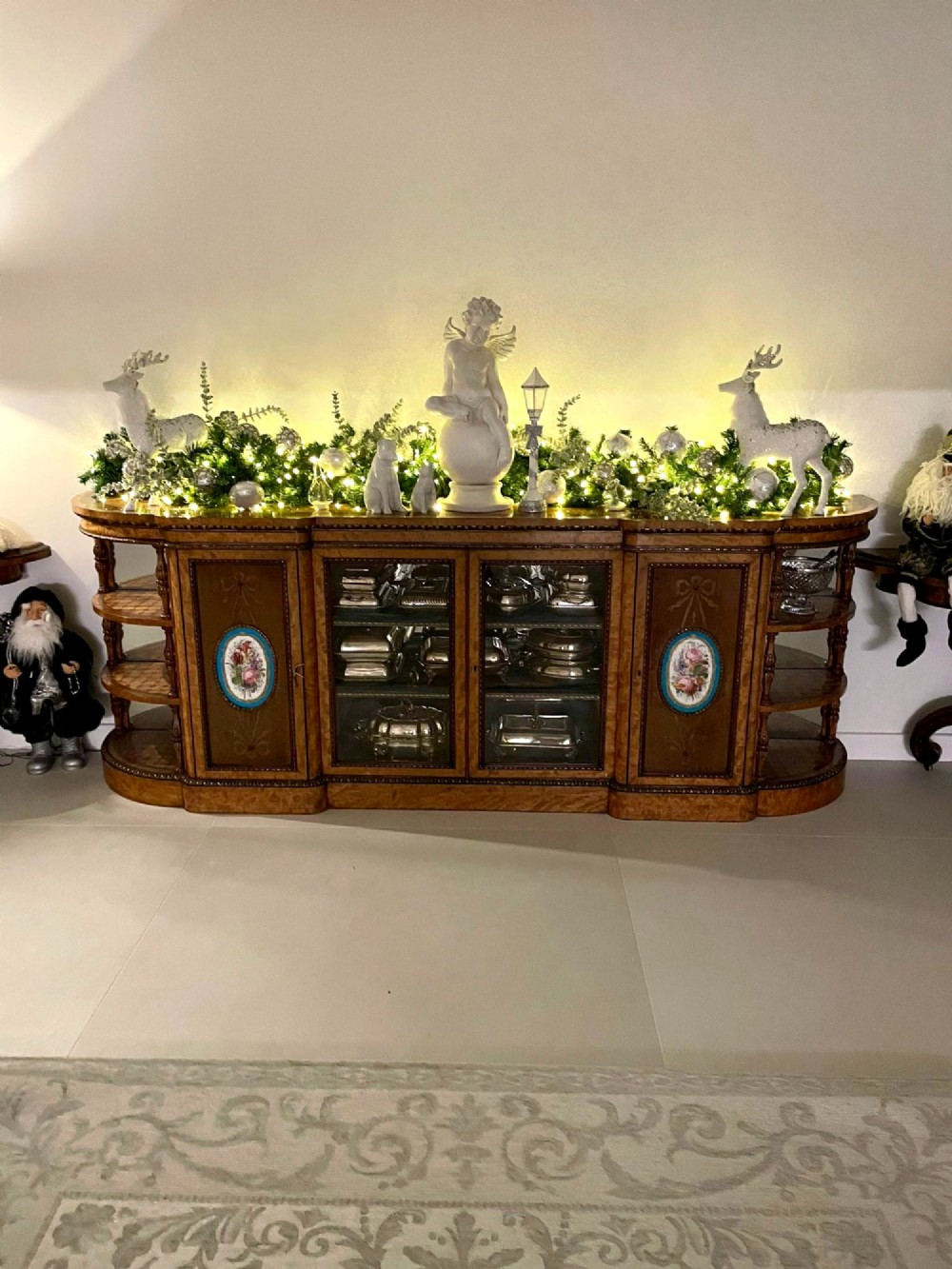 A large Victorian satinwood credenza featuring central glazed doors, oval porcelain plaques, and open curved side shelves. View XIV