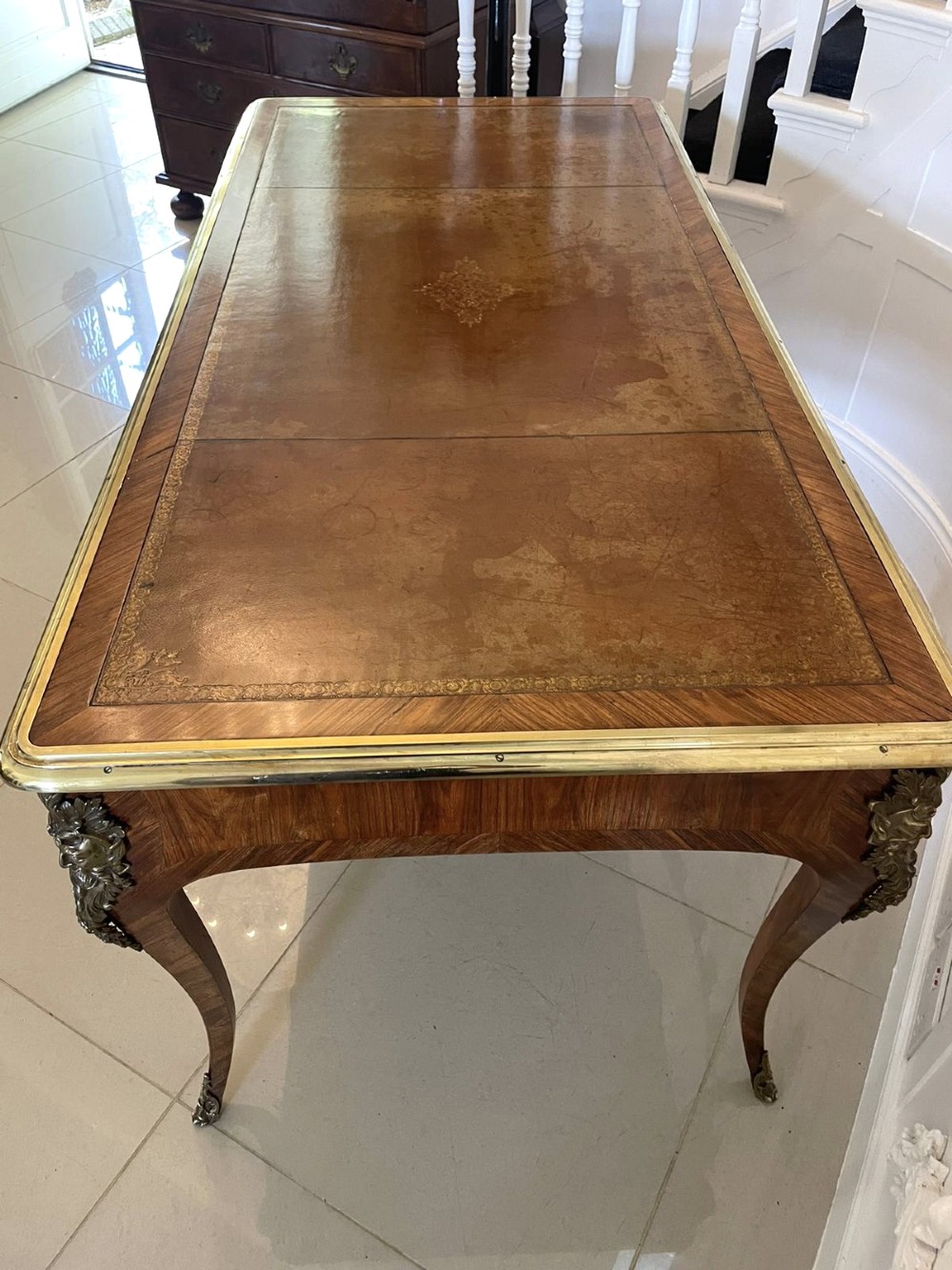 A French Louis XV style kingwood bureau plat featuring cabriole legs with ormolu mounts, three frieze drawers, and a leather inset writing surface. View VII