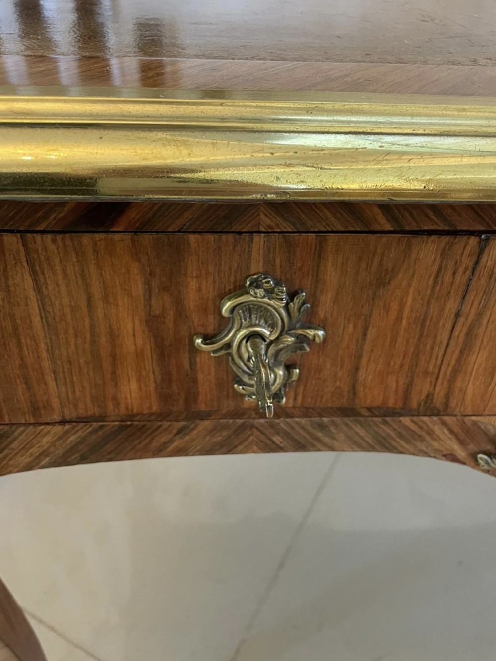 A French Louis XV style kingwood bureau plat featuring cabriole legs with ormolu mounts, three frieze drawers, and a leather inset writing surface. View IX