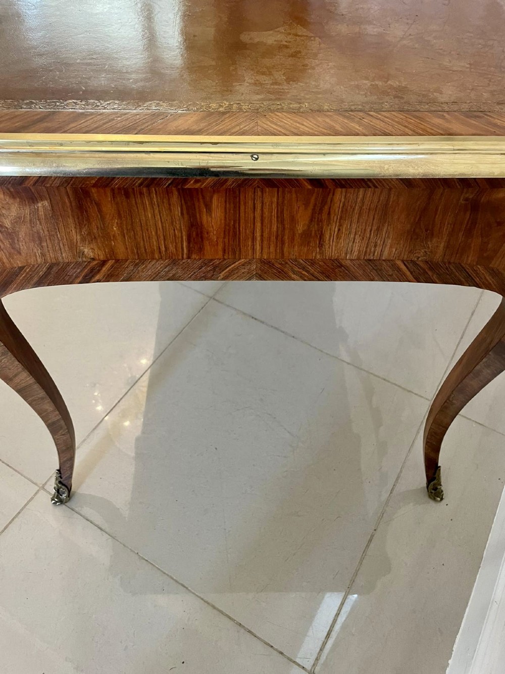A French Louis XV style kingwood bureau plat featuring cabriole legs with ormolu mounts, three frieze drawers, and a leather inset writing surface. View X