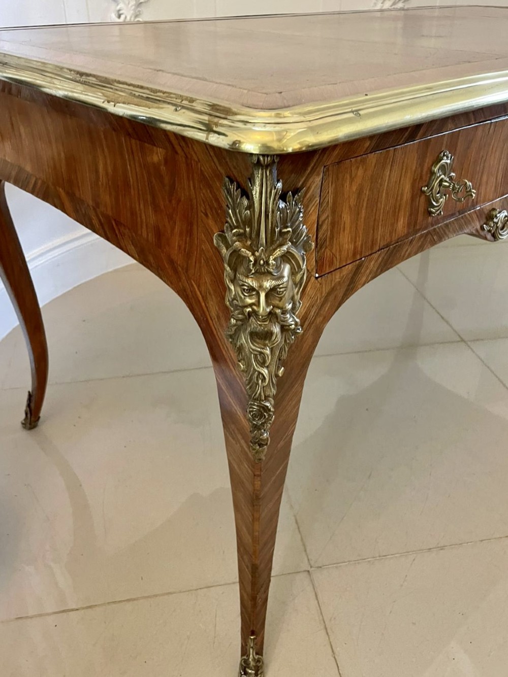 A French Louis XV style kingwood bureau plat featuring cabriole legs with ormolu mounts, three frieze drawers, and a leather inset writing surface. View XIV