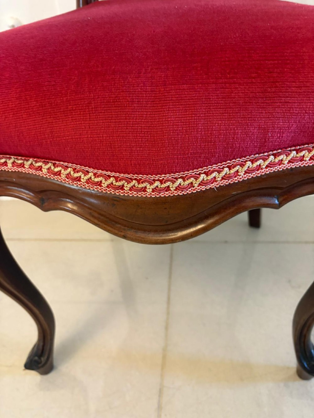 A set of Victorian carved mahogany dining chairs featuring open balloon-style backs and red velvet upholstered seats. View II