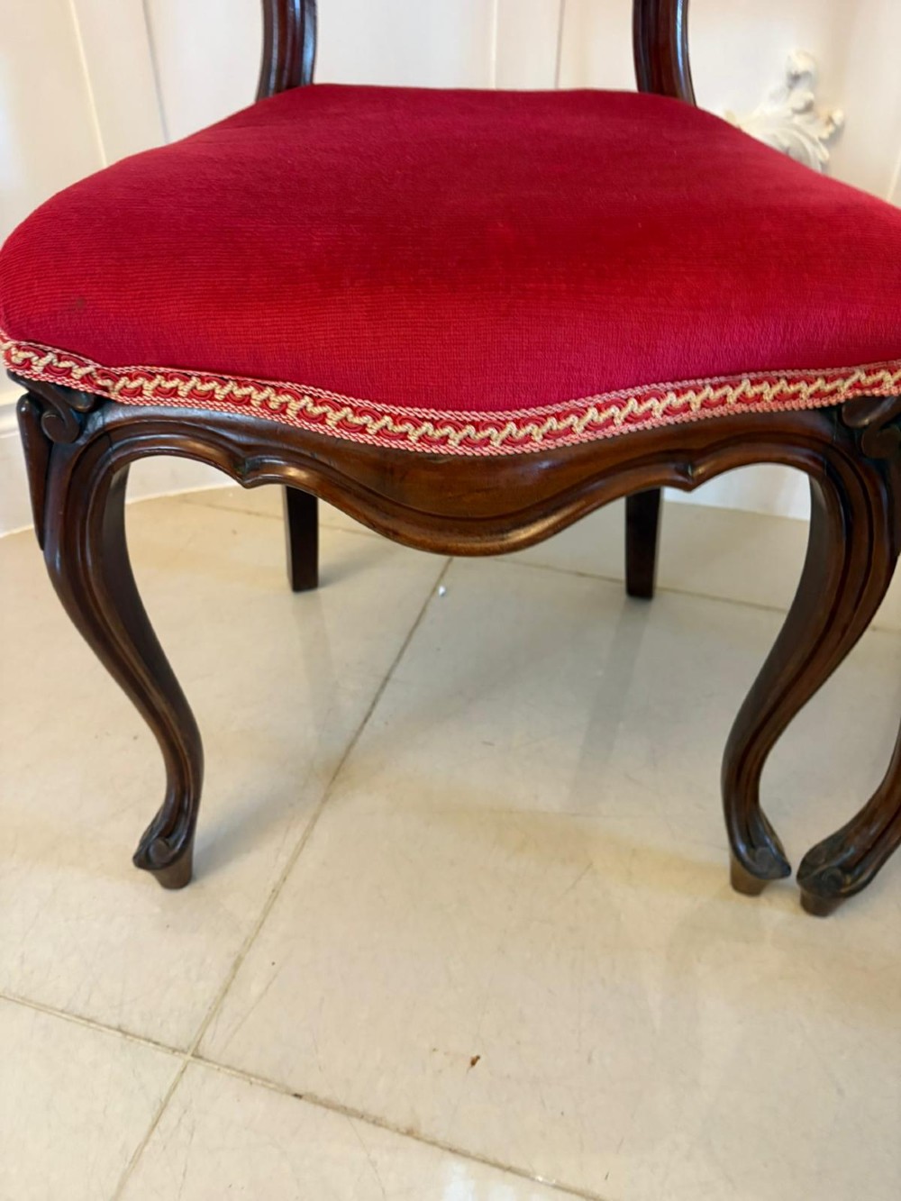 A set of Victorian carved mahogany dining chairs featuring open balloon-style backs and red velvet upholstered seats. View IV