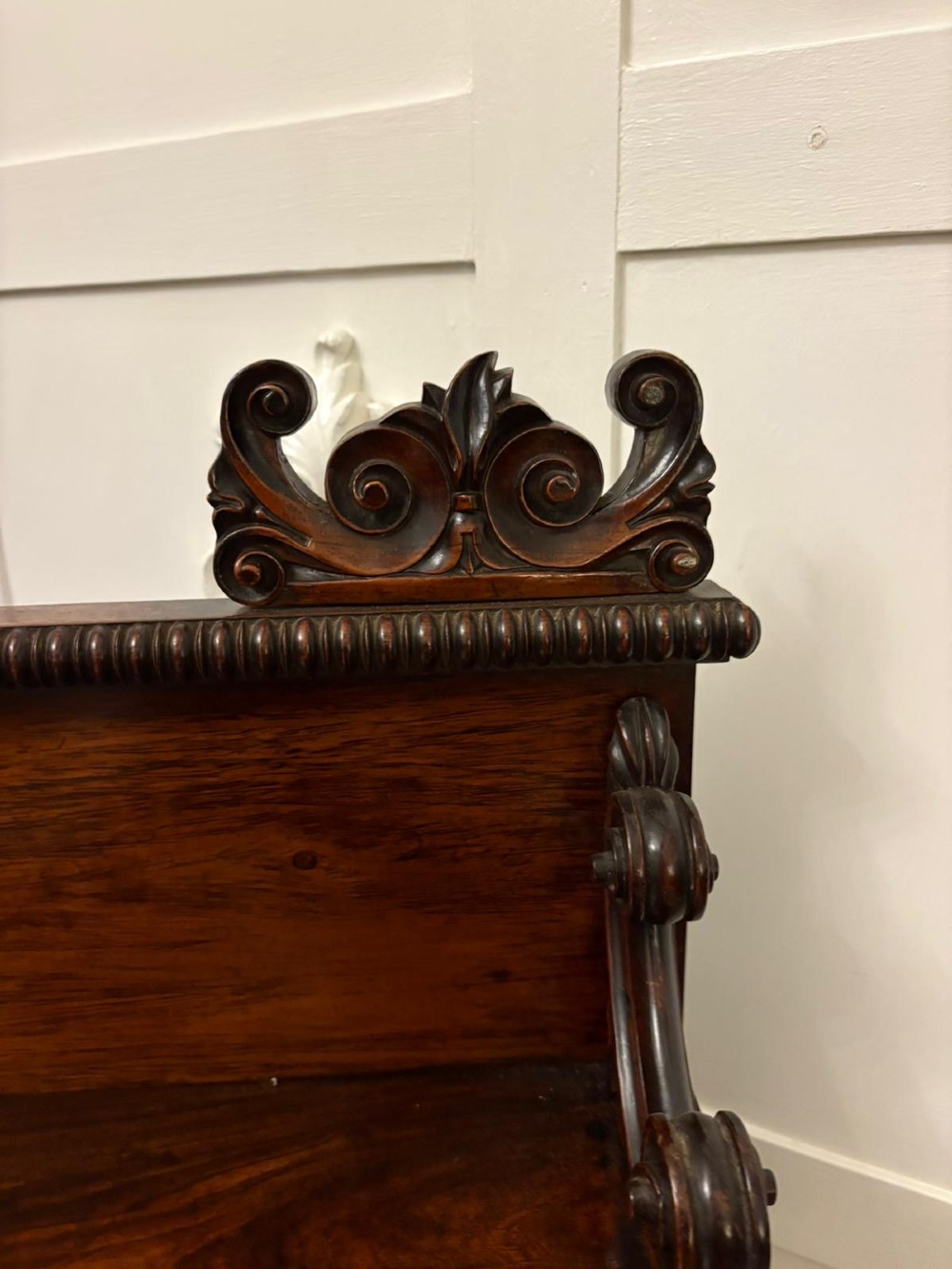 A dark mahogany Regency chiffonier sideboard featuring a two-door lower cupboard, turned support columns, carved claw feet, and a raised upper display shelf with a carved scroll cresting. View IV