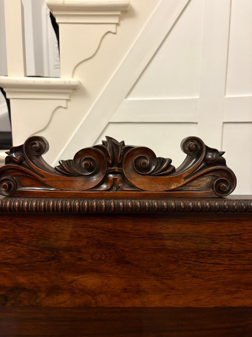 A dark mahogany Regency chiffonier sideboard featuring a two-door lower cupboard, turned support columns, carved claw feet, and a raised upper display shelf with a carved scroll cresting. View VI
