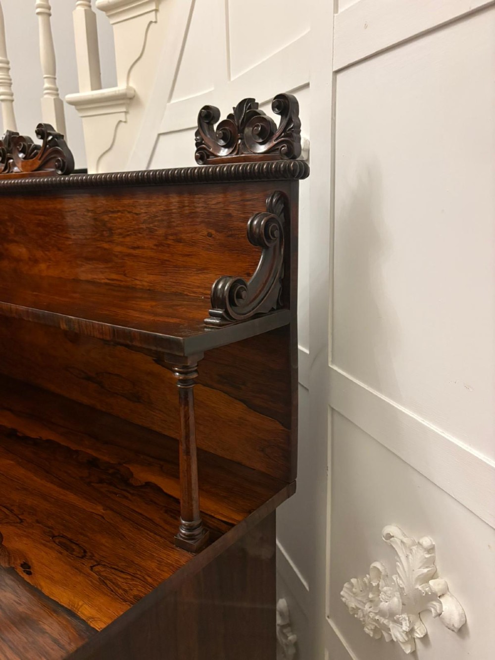 A dark mahogany Regency chiffonier sideboard featuring a two-door lower cupboard, turned support columns, carved claw feet, and a raised upper display shelf with a carved scroll cresting. View VIII