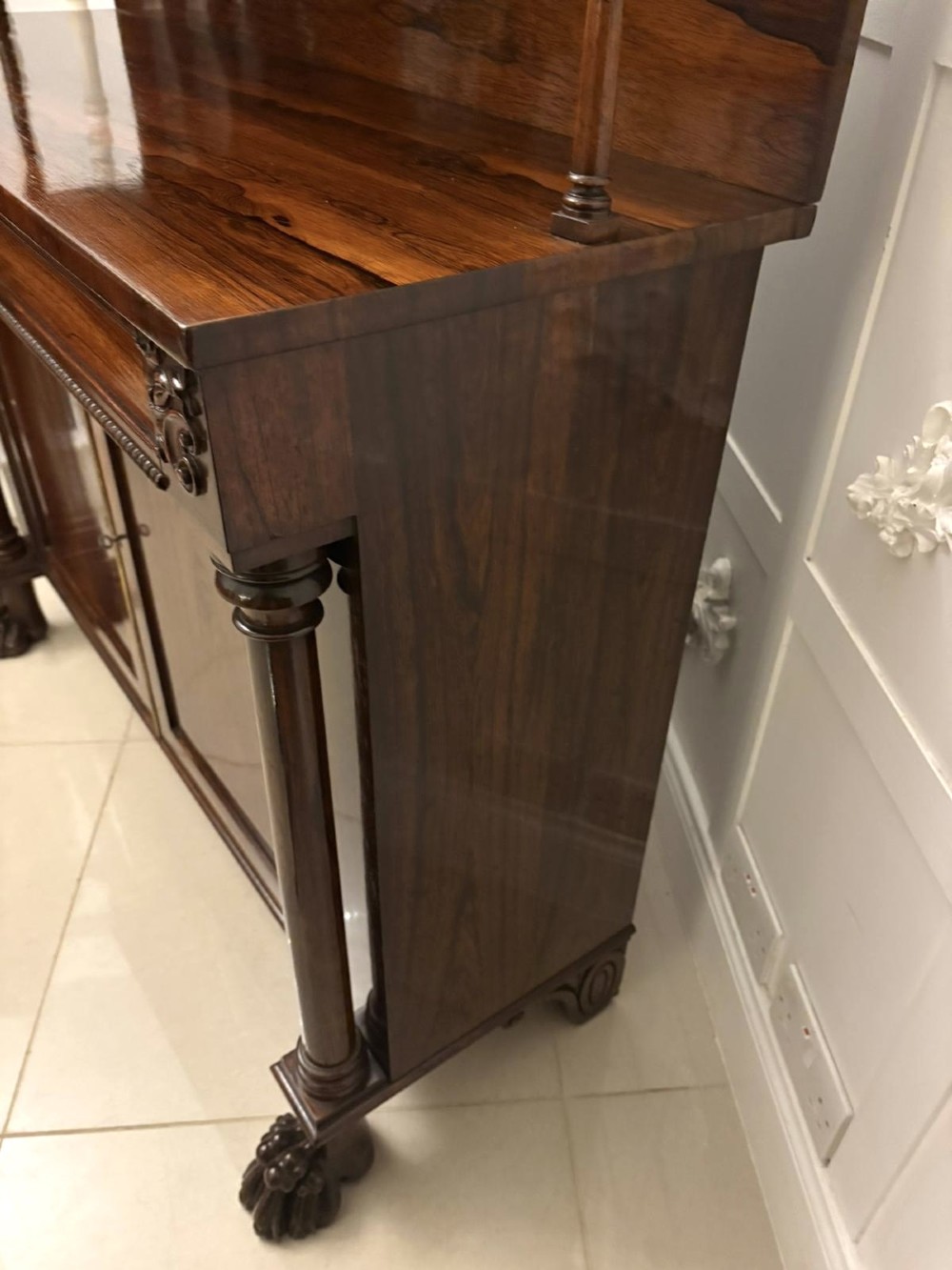 A dark mahogany Regency chiffonier sideboard featuring a two-door lower cupboard, turned support columns, carved claw feet, and a raised upper display shelf with a carved scroll cresting. View IX