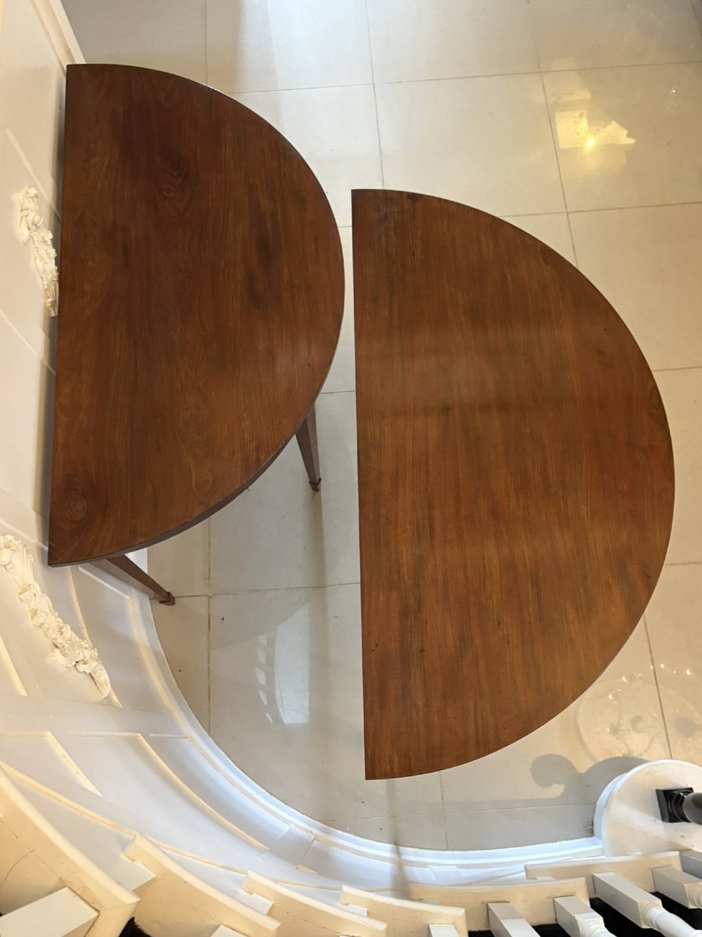 A pair of George III mahogany demi-lune console tables with polished semi-circular tops and tapered square legs. View X