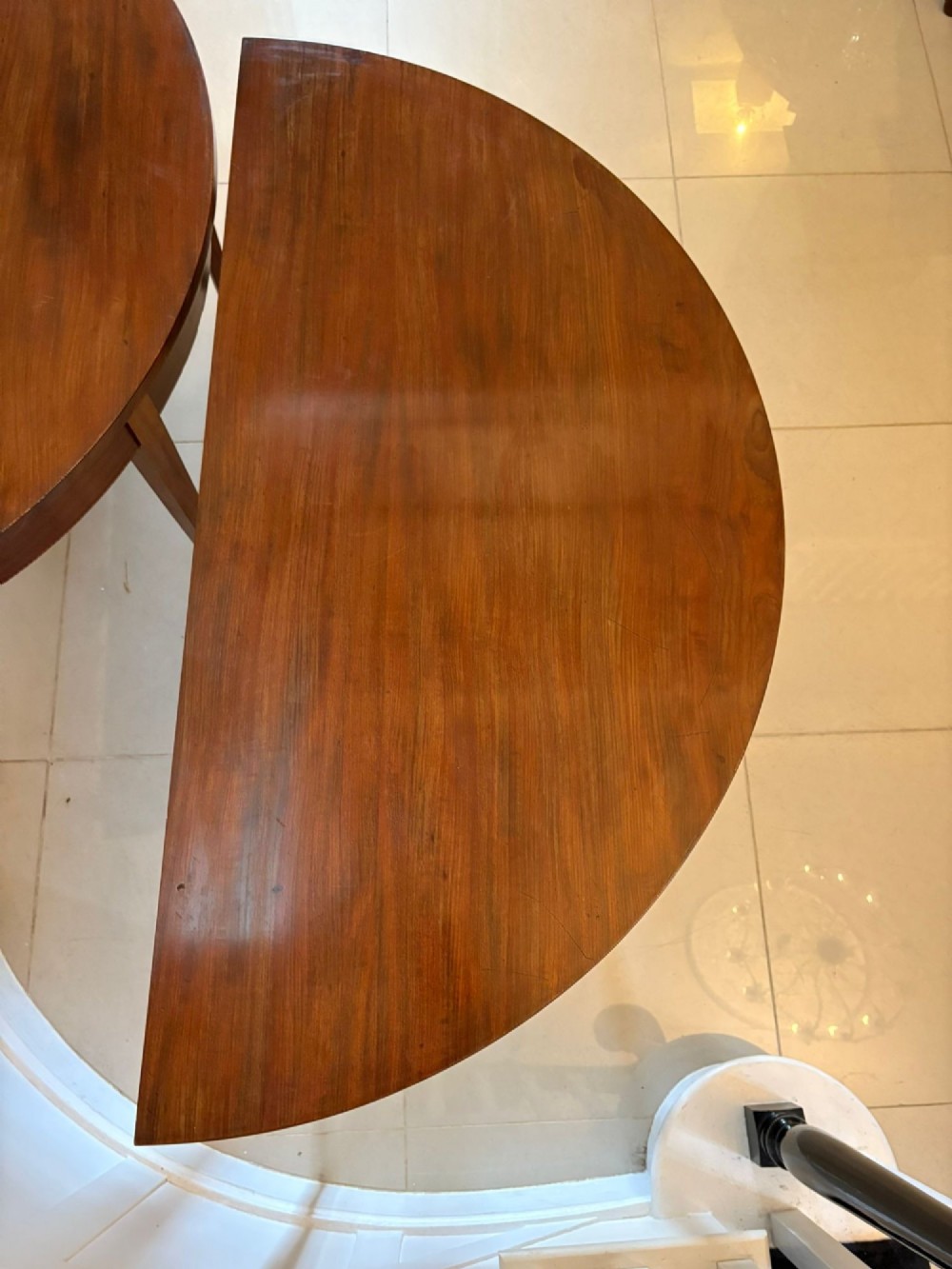 A pair of George III mahogany demi-lune console tables with polished semi-circular tops and tapered square legs. View XII