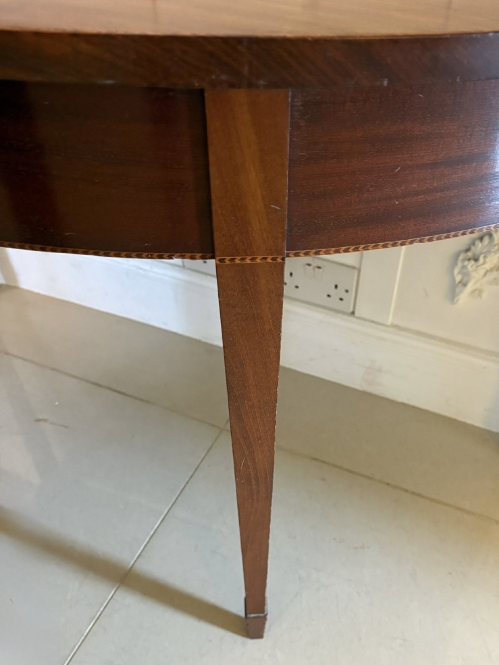 A pair of George III mahogany demi-lune console tables with polished semi-circular tops and tapered square legs. View XIII