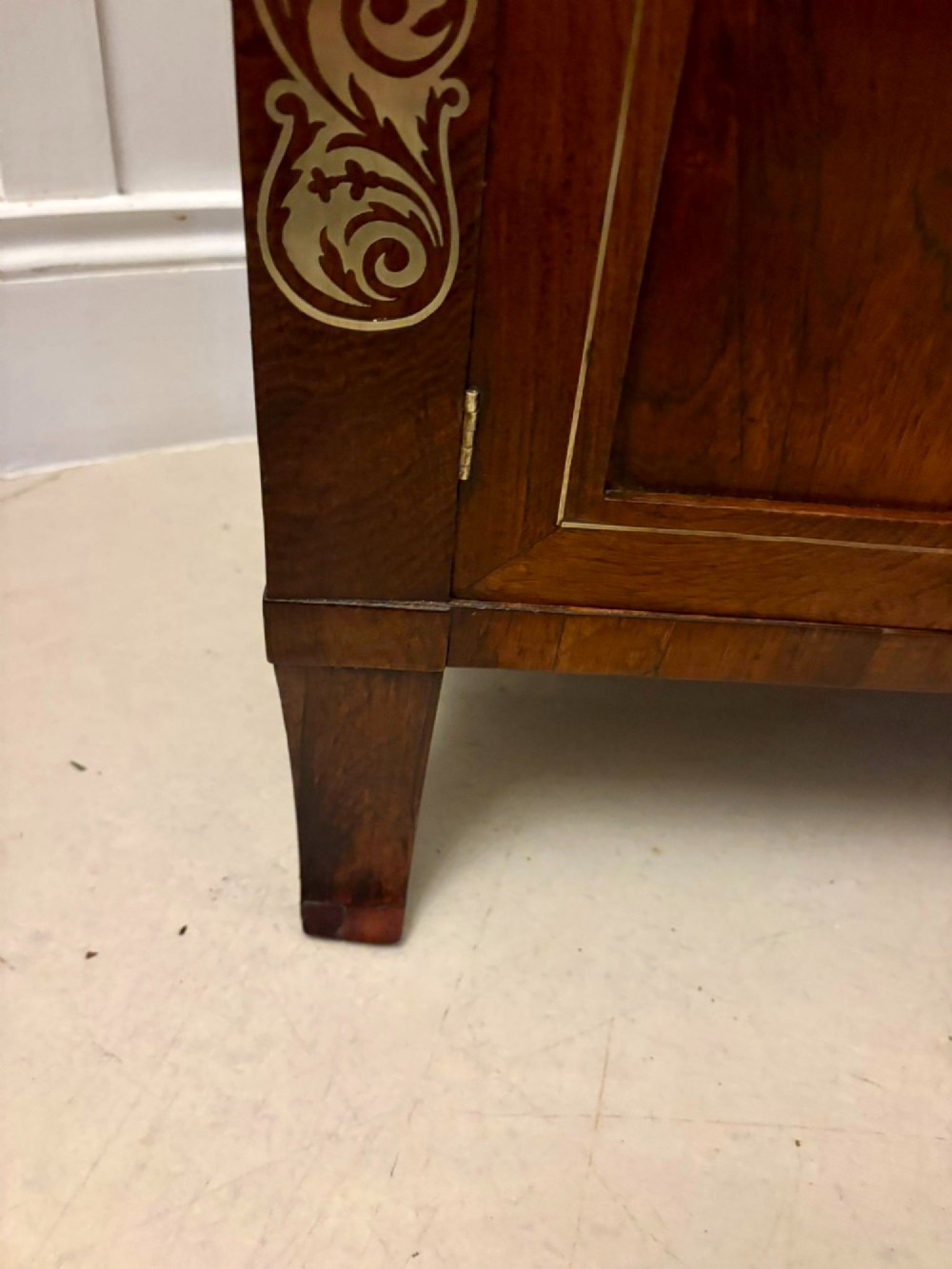 An antique Regency mahogany chiffonier side cabinet featuring intricate floral brass inlay on the doors and frieze with an upper open shelf. View III