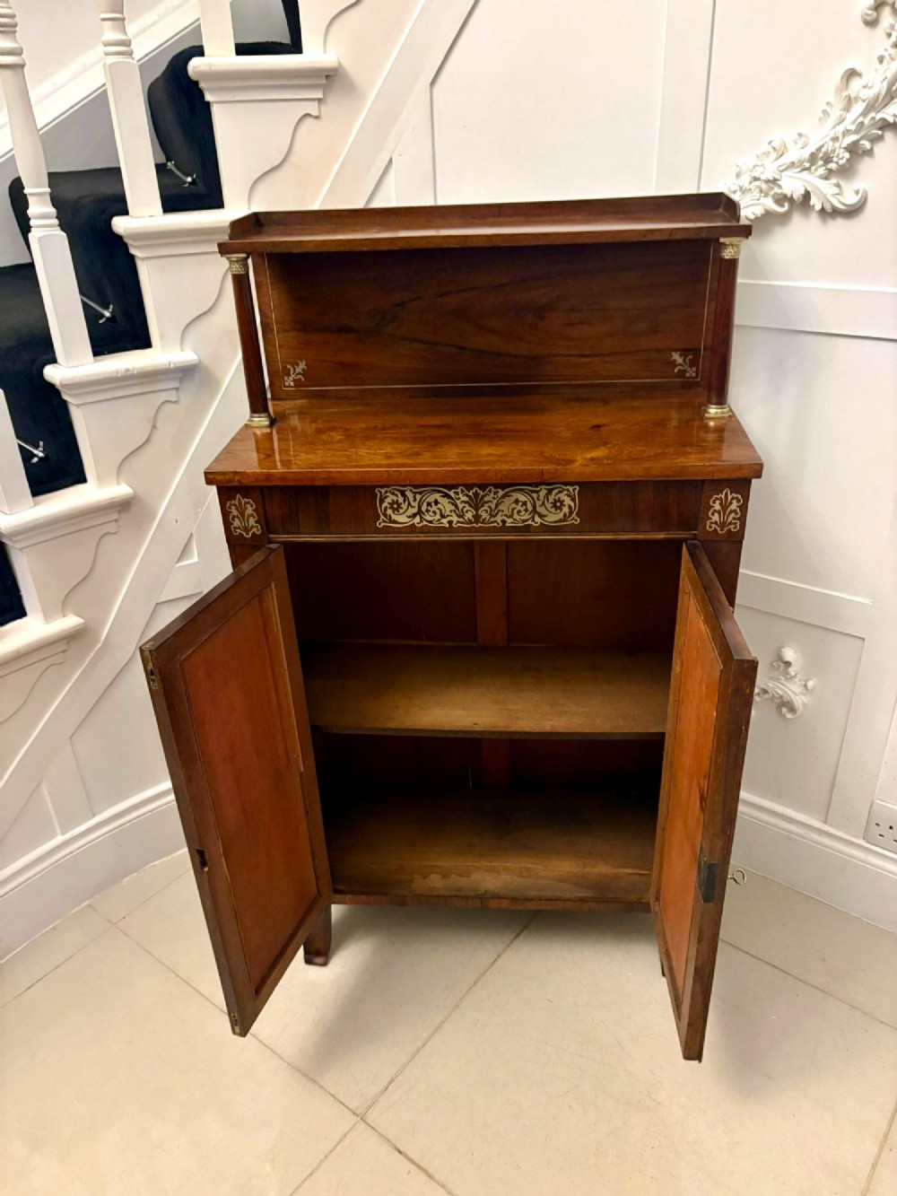 An antique Regency mahogany chiffonier side cabinet featuring intricate floral brass inlay on the doors and frieze with an upper open shelf. View XII