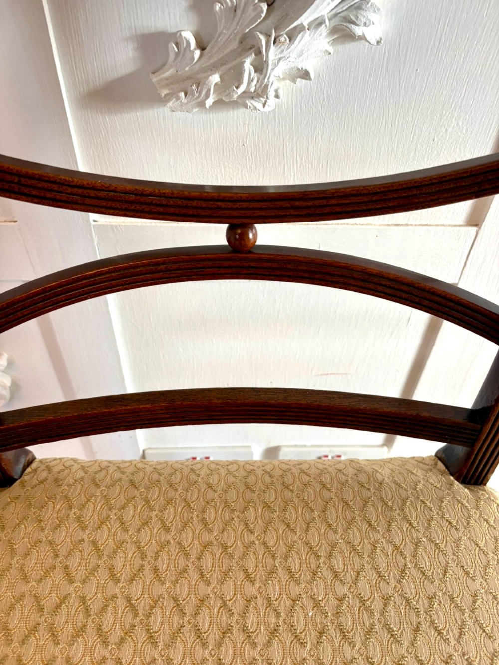 A set of eight George III style mahogany dining chairs featuring two carvers and six side chairs with reeded frames and patterned cream upholstered seats. View VIII