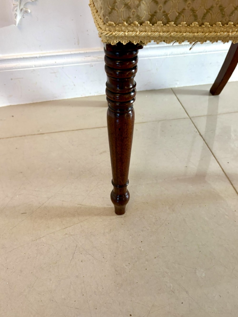 A set of eight George III style mahogany dining chairs featuring two carvers and six side chairs with reeded frames and patterned cream upholstered seats. View IX