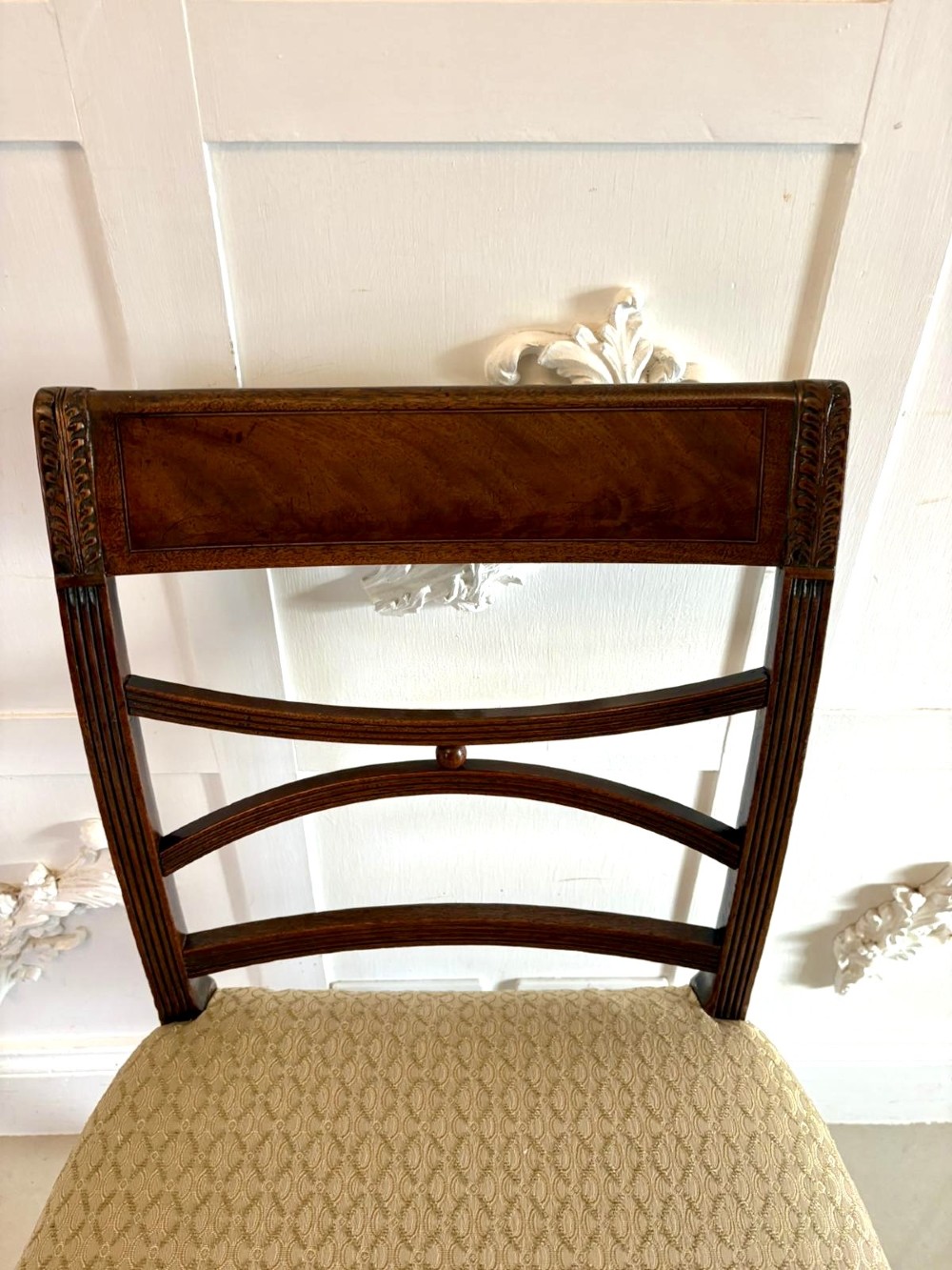 A set of eight George III style mahogany dining chairs featuring two carvers and six side chairs with reeded frames and patterned cream upholstered seats. View XI