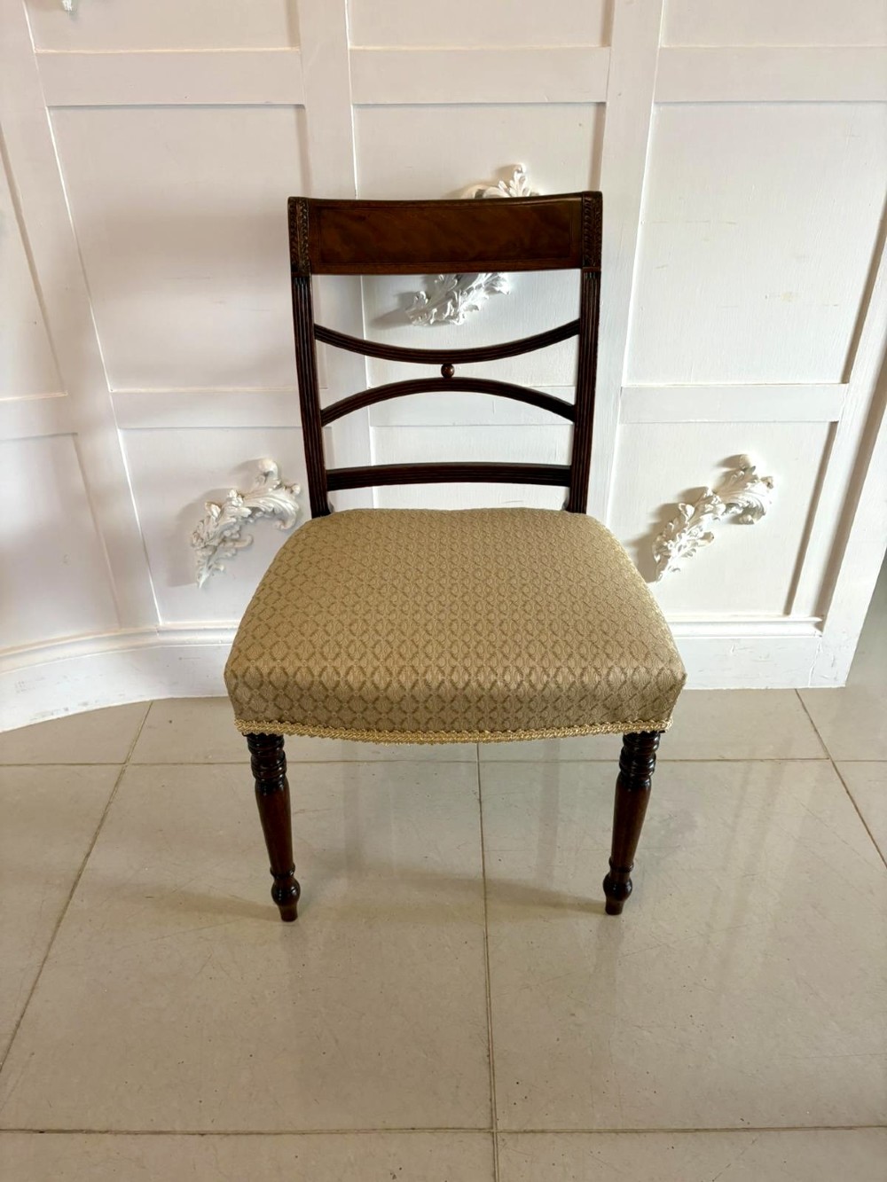 A set of eight George III style mahogany dining chairs featuring two carvers and six side chairs with reeded frames and patterned cream upholstered seats. View XII