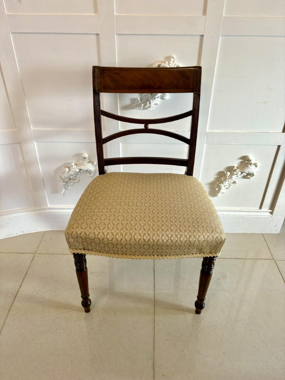 A set of eight George III style mahogany dining chairs featuring two carvers and six side chairs with reeded frames and patterned cream upholstered seats. View XIII