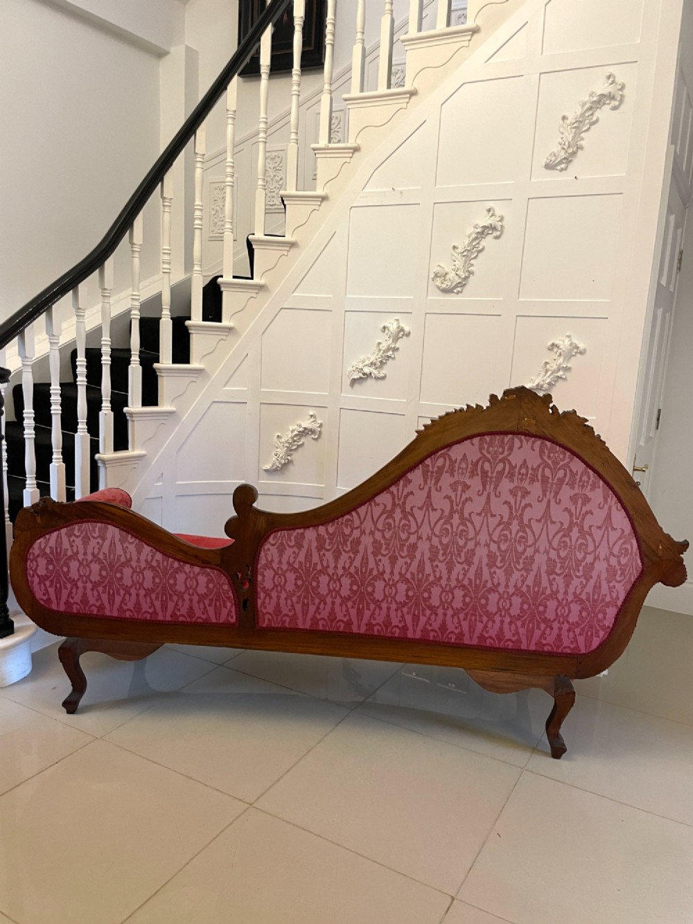 An antique Victorian carved mahogany chaise longue upholstered in deep red damask fabric with cabriole legs and ornate timber carving. View XI