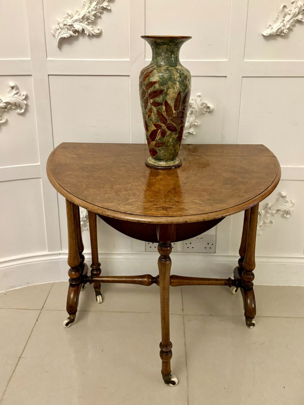 A tall Victorian glazed stoneware vase featuring a mottled green background decorated with brown leaf impressions and a flared rim. View II