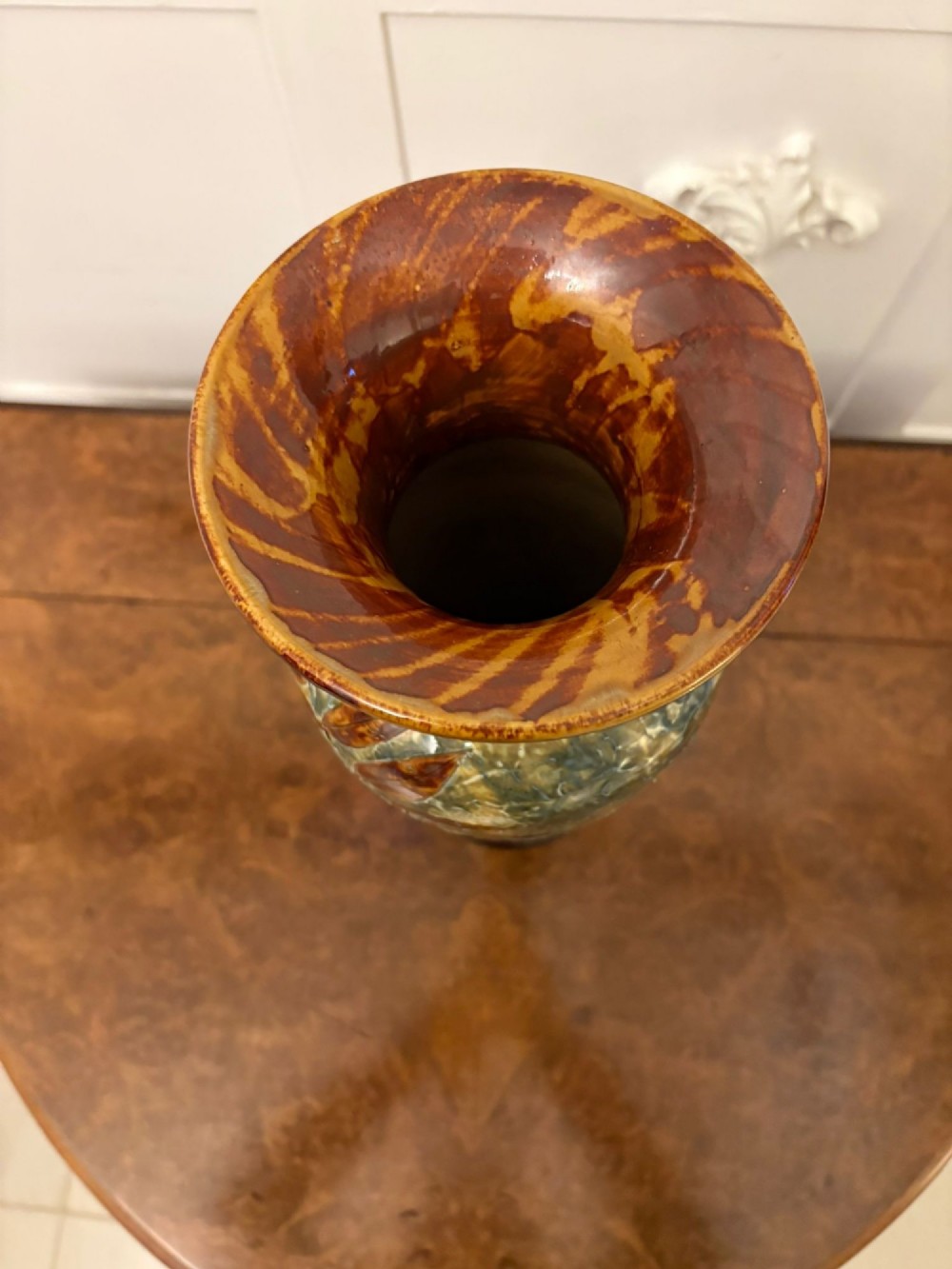 A tall Victorian glazed stoneware vase featuring a mottled green background decorated with brown leaf impressions and a flared rim. View V
