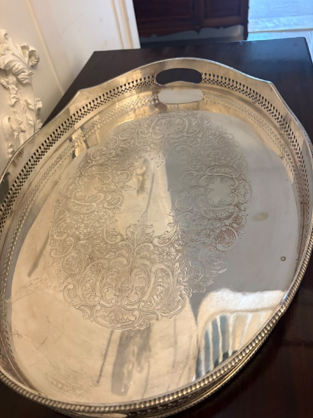 An oval Edwardian silver plated serving tray with an engraved foliate surface pattern and a pierced gallery border featuring cut-out hand grips. View VII