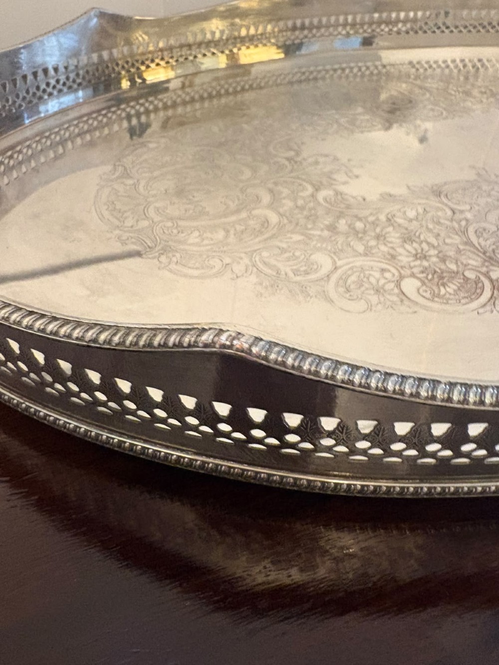 An oval Edwardian silver plated serving tray with an engraved foliate surface pattern and a pierced gallery border featuring cut-out hand grips. View VIII