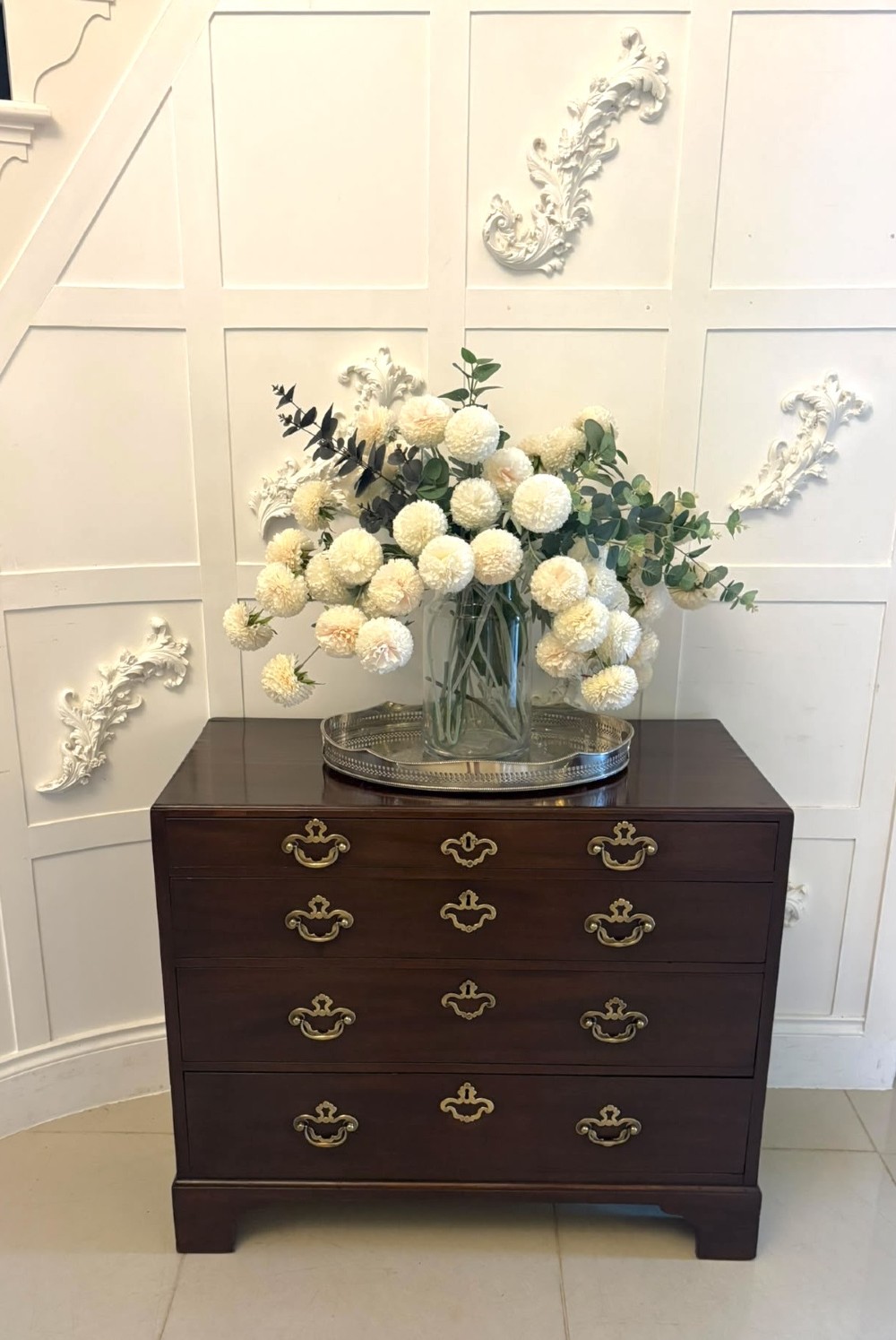 A George II mahogany chest of drawers featuring an open top writing drawer with an adjustable gilt-tooled green leather surface and brass handles. View IX