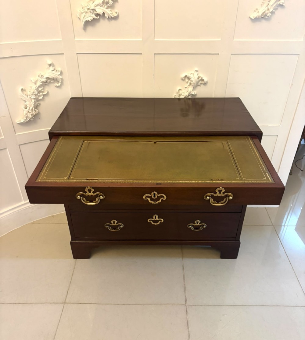 A George II mahogany chest of drawers featuring an open top writing drawer with an adjustable gilt-tooled green leather surface and brass handles. View XI