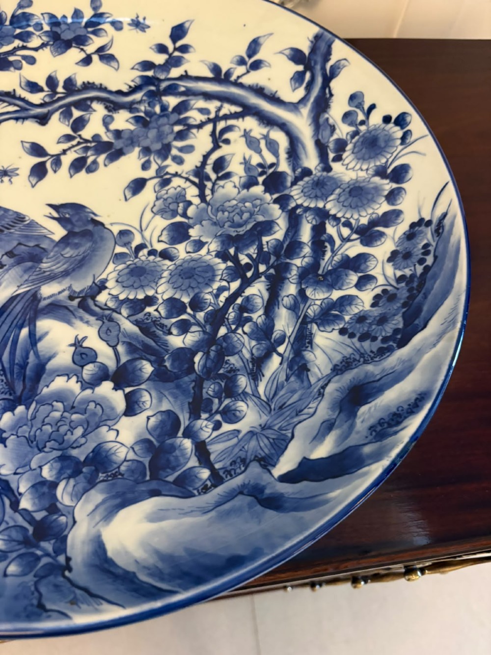 A pair of large circular blue and white Chinese porcelain chargers decorated with hand-painted birds and flowering branches. View IX