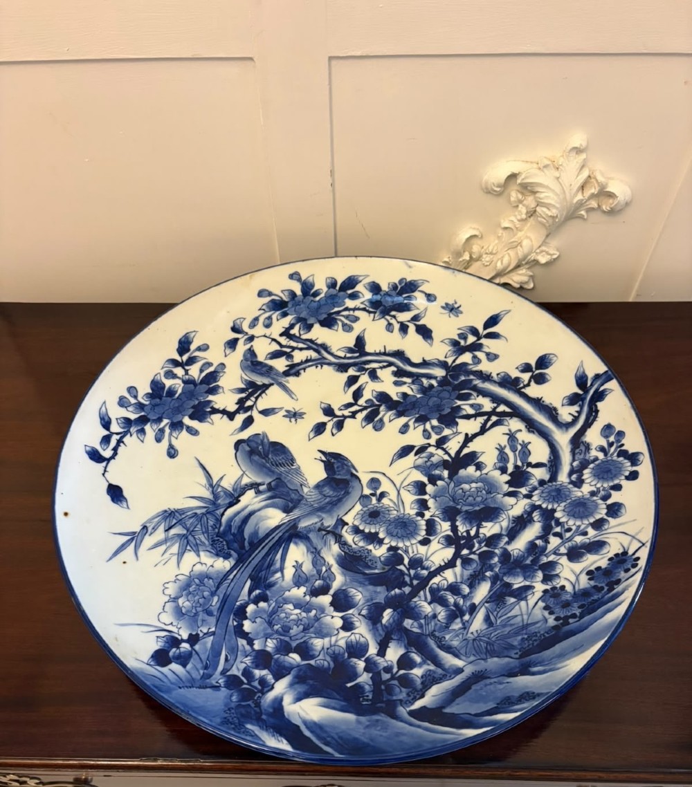 A pair of large circular blue and white Chinese porcelain chargers decorated with hand-painted birds and flowering branches. View XV